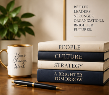 Stacked books labelled People, Culture, Strategy and A Brighter Tomorrow beside a mug reading Ideas Change Work